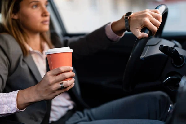 Close Businesswoman Holding Cup Coffee While Driving Car Commuting Work — 图库照片