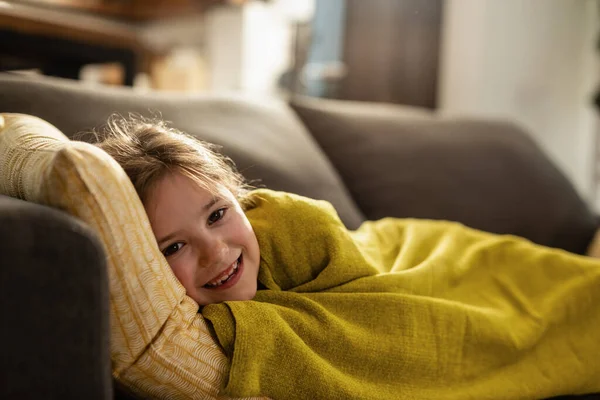 Cute Happy Girl Covered Blanket Lying Sofa Home Looking Camera — 图库照片