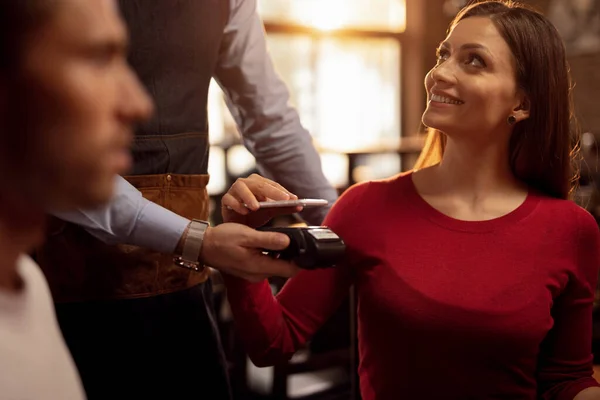Young Happy Woman Using Smart Phone Making Contactless Payment While —  Fotos de Stock
