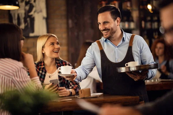 Happy Waiter Serving Female Guests Giving Them Coffee Coffee Shop — 스톡 사진