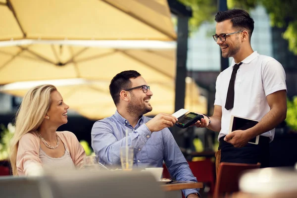 Happy Waiter Taking Contactless Mobile Phone Payment His Guests Bar — Fotografia de Stock