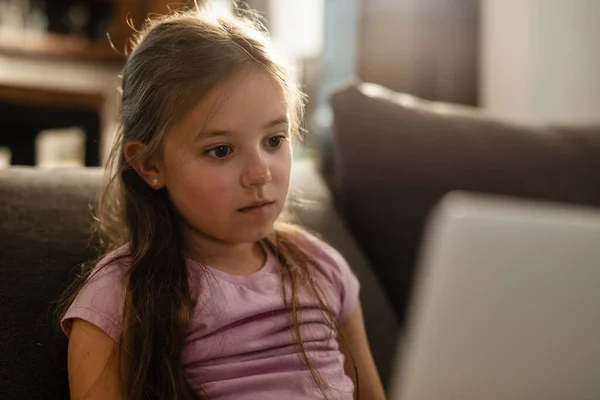 Thoughtful Small Girl Surfing Net Computer Home — Stockfoto