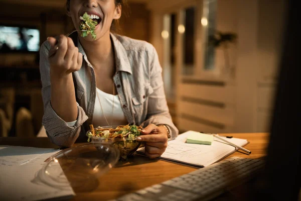 Female Freelancer Using Computer Eating Salad Night Home —  Fotos de Stock