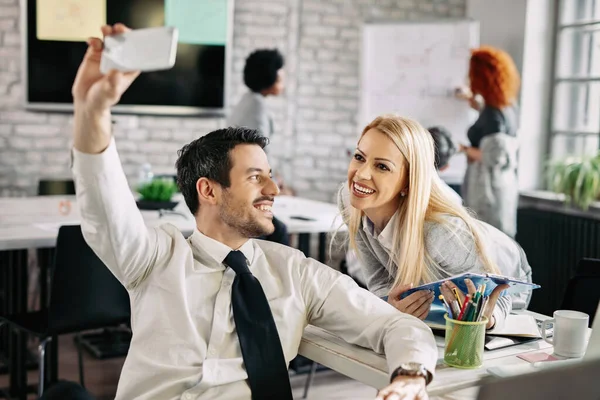 Two Happy Business People Using Smart Phone Taking Selfie While — Fotografia de Stock