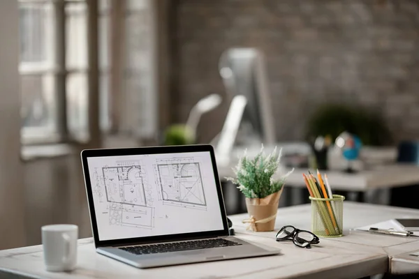 Housing plans on computer monitor on a desk in the office.