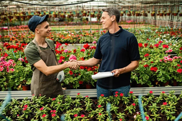 Young Happy Worker Handshaking Quality Control Inspector While Working Greenhouse — Fotografia de Stock