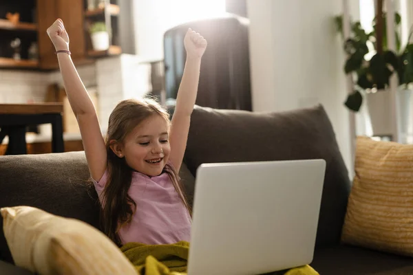 Happy Little Girl Arms Raised Celebrating While Playing Games Computer — Stockfoto