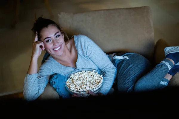 Young Happy Woman Watching While Relaxing Armchair Night Home — Stockfoto