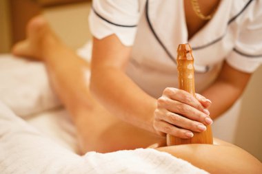 Close-up of woman having anti cellulite massage during spa treatment at beauty salon.  clipart