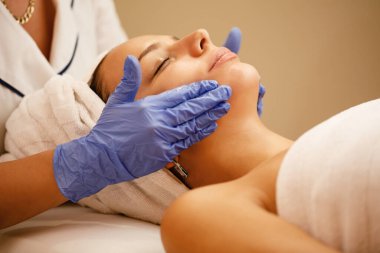 Close-up of relaxed woman enjoying in beauty treatment at the spa. 