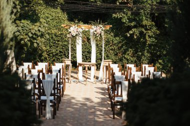 Rustic decorated wedding aisle in a garden. 