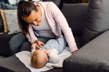 Happy mother spending time with her baby and enjoying in motherhood. 