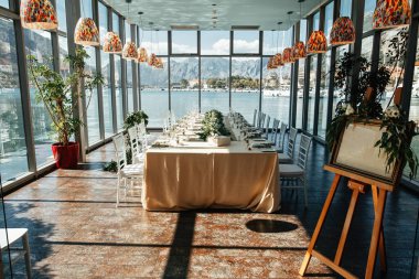 Romantic wedding reception hall with decorated dining table. 