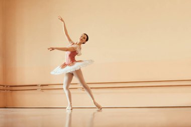 Full length of smiling ballet dances rehearsing at dance studio. Copy space.