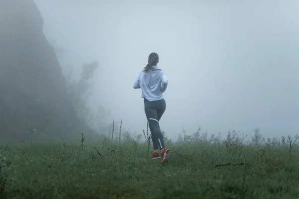 Back View Athlete Woman Running Foggy Meadow Copy Space — Stock Fotó