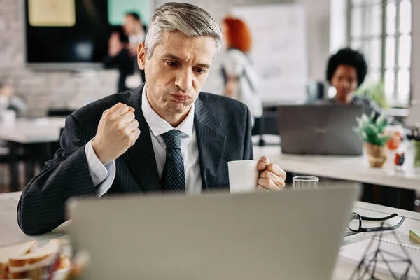 Confident Businessman Doing Fist Pump Celebrating While Working Laptop Office — Stock Fotó