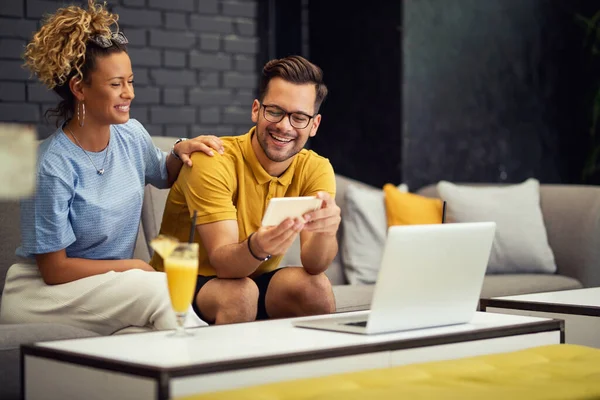 Young Happy Couple Having Fun While Surfing Net Smart Phone — Photo