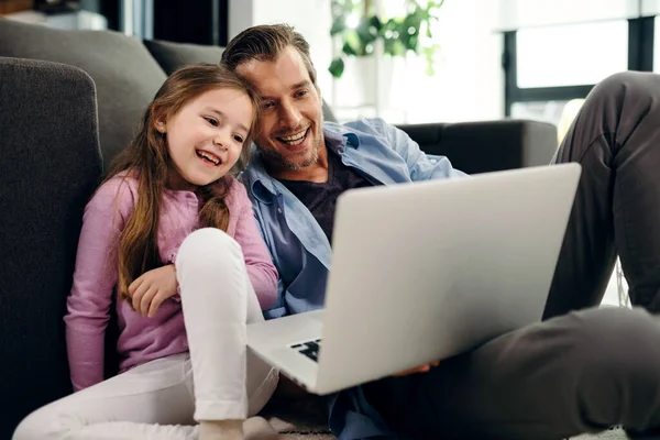 Happy Little Girl Her Father Watching Something Computer While Relaxing — Stockfoto