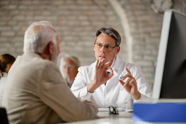 Male Doctor Explaining Dose Prescription Medicine His Mature Patient Meeting — Foto de Stock