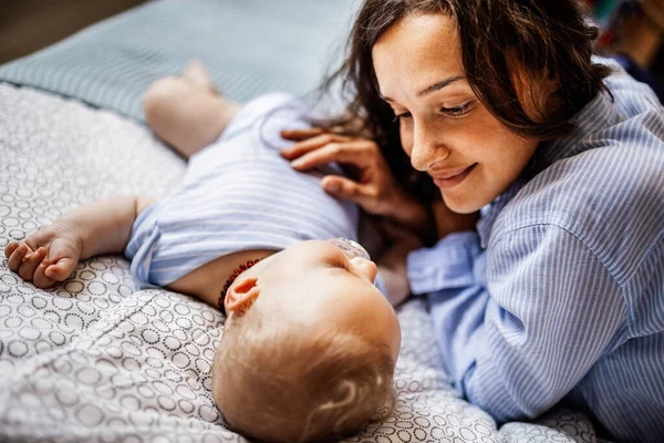 Young Smiling Mother Enjoying While Looking Her Sleeping Baby Boy — Stock Photo, Image