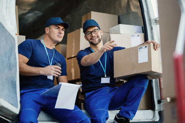 Young Courier Pointing Something While Witting His Coworker Back Delivery — Foto Stock