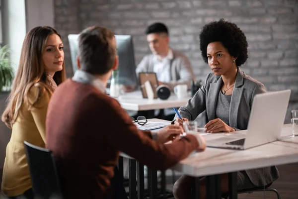 Black Female Insurance Agent Taking Notes While Communicating Couple Meeting — Stock Fotó