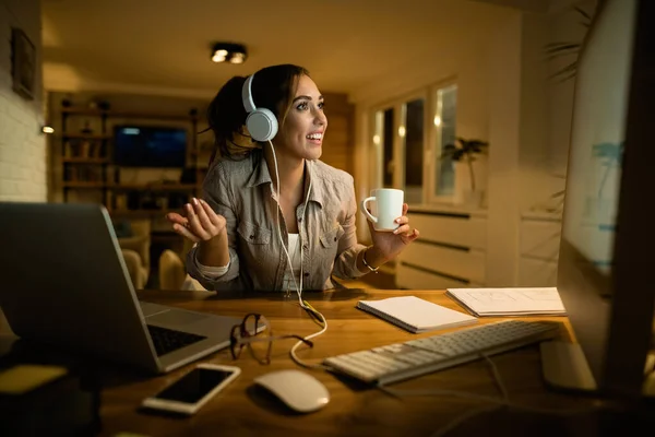 Young Woman Headphones Drinking Coffee While Having Video Chat Desktop — Foto de Stock