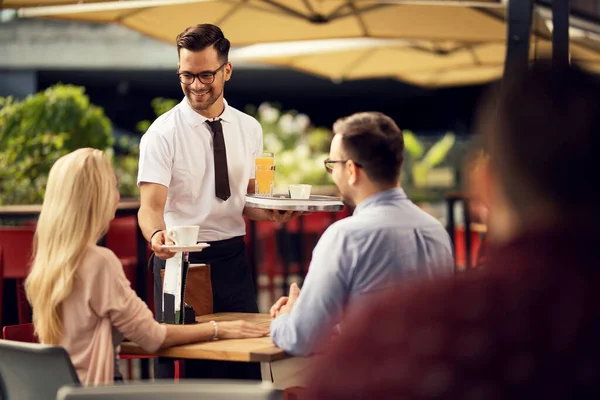 Happy Waiter Giving Coffee Couple While Serving Them Outdoor Cafe — Foto de Stock