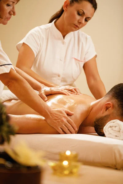 Unrecognizable Man Enjoying Four Hands Back Massage Spa Treatment — Foto de Stock