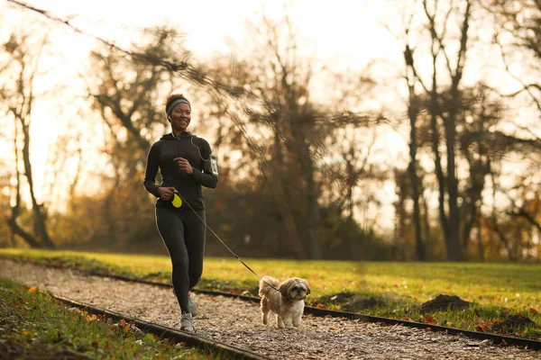 Happy Black Sportswoman Running Her Dog Park — Stock Fotó