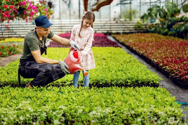 Young Worker Teaching Small Girl How Water Plants While Using — Fotografia de Stock
