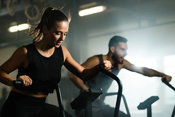 Young Sports People Exercising Stationary Bikes Cross Training Gym Focus — Stockfoto