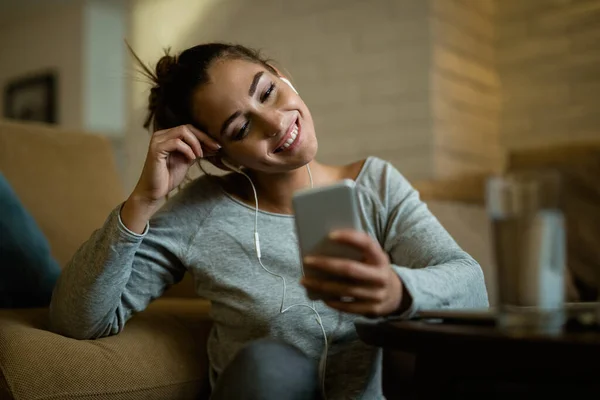 Young Happy Woman Enjoying Evening While Using Smart Phone Living — Zdjęcie stockowe