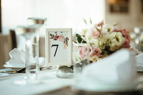 Details on decorated dining table at wedding reception.