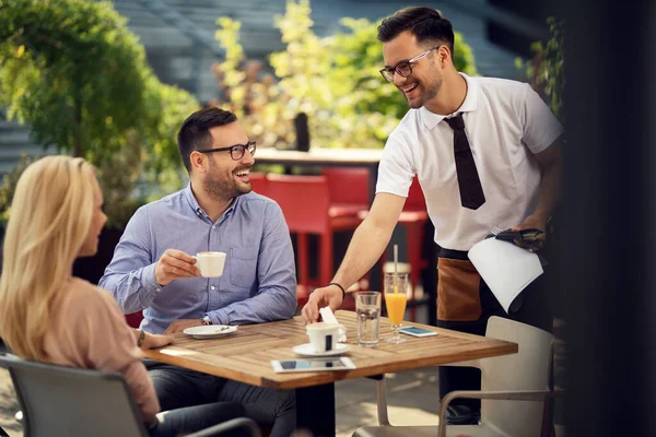 Happy Couple Talking Waiter While Setting Table Lunch Restaurant —  Fotos de Stock