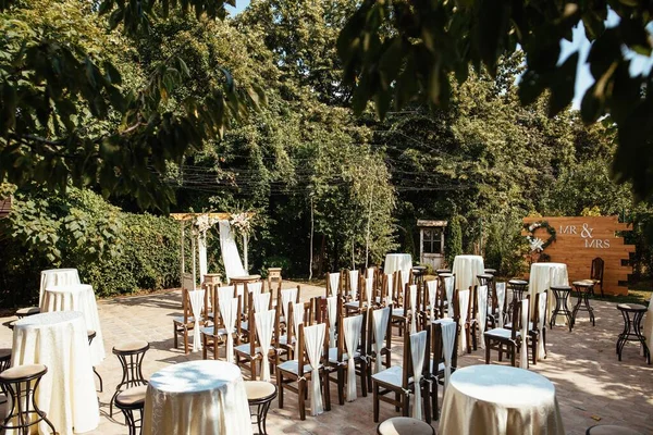 Decorated wedding aisle for marriage ceremony in a garden.