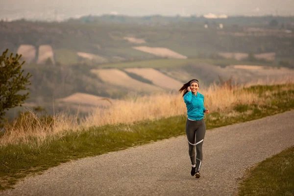 Full Length Female Runner Listening Music While Jogging Road Dawn — Stock Fotó