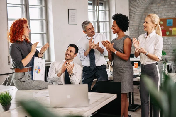 Happy business team celebrating and applauding themselves after successful project they have been working on together. 