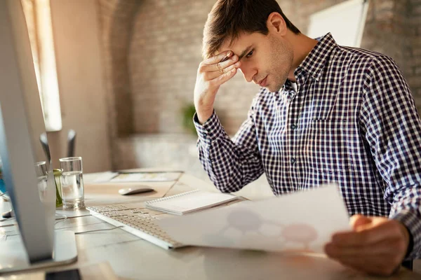 Young Businessman Feeling Worried While Analyzing Business Plans Office — Foto de Stock