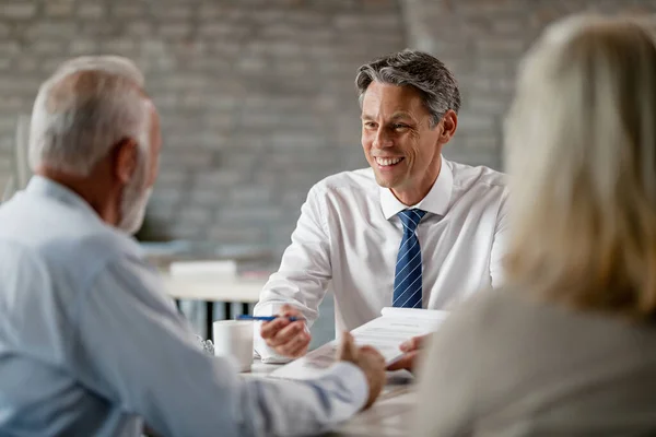 Happy Insurance Agent Communicating Senior Clients While Going Paperwork Meeting — Fotografia de Stock