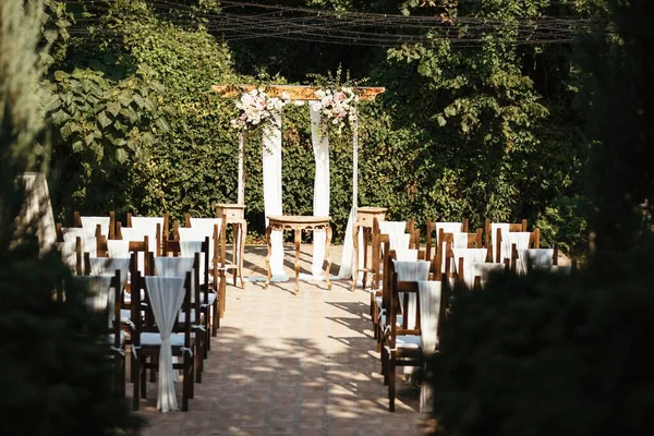 Rustic decorated wedding aisle in a garden.