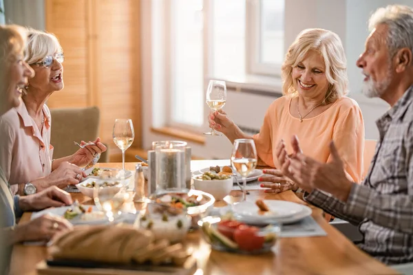 Happy Mature Friends Enjoying Conversation While Having Lunch Drinking Wine — Zdjęcie stockowe