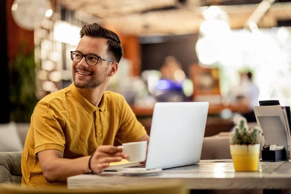 Happy Male Student Using Laptop While Having Coffee Break Cafe — Foto de Stock