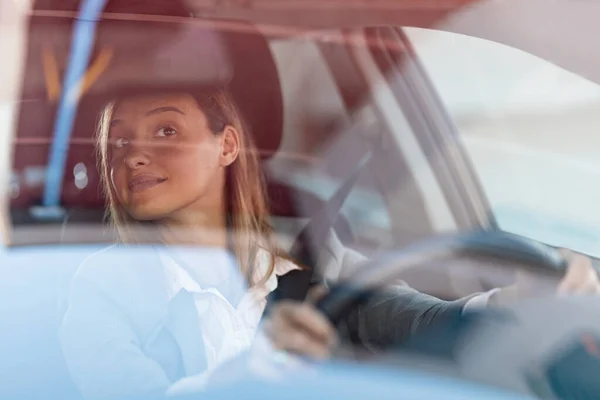 Young Smiling Businesswoman Driving Car Looking Herself Rearview Mirror View — Stockfoto