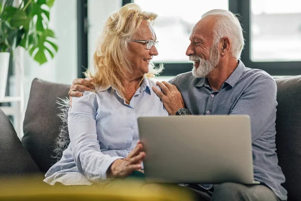 Happy Senior Couple Looking Each Other Communicating While Surfing Net — 스톡 사진
