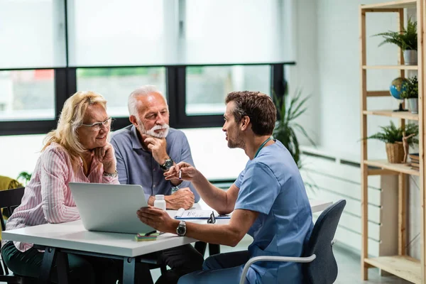 Happy Mature Couple Doctor Communicating While Using Laptop Medical Appointment — Fotografia de Stock