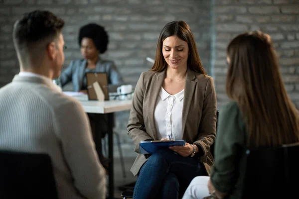 Smiling Insurance Agent Reading Documents While Having Meeting Young Couple — Photo