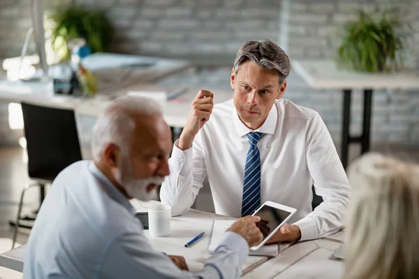 Financial Advisor Senior Couple Using Digital Tablet While Having Meeting — Stock Fotó