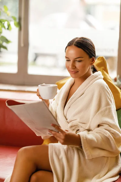 Young Woman Enjoying Relaxing Day While Drinking Tea Reading Magazine — Stockfoto
