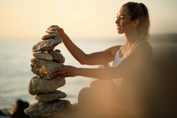Happy Athletic Woman Stacking Stones Yoga Exercises Morning Beach — ストック写真